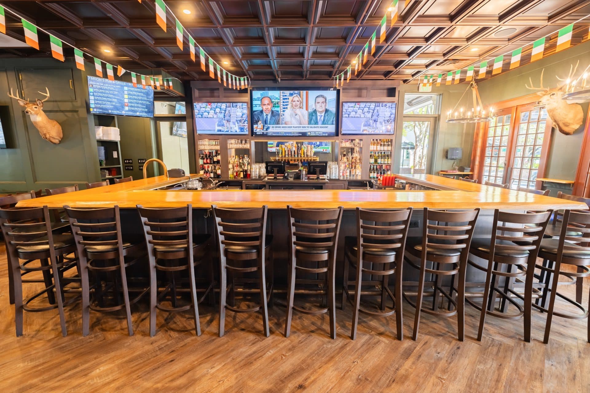Bar Seating at O'Brion's Pub & Grille — Full Bar, Draft Taps & Live Sports Front view of the full bar seating area at O'Brion's Pub & Grille Mount Pleasant with bar stools, draft taps, and mounted TVs