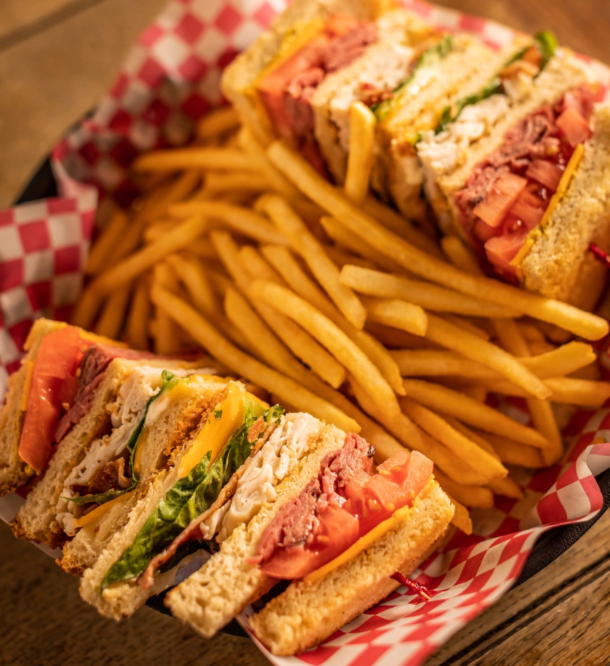 Colossal Club Sandwich at O'Brion's Pub & Grille — Mount Pleasant SC Colossal Club sandwich with turkey, roast beef, cheddar, bacon, and lettuce on sourdough at O'Brion's Pub & Grille
