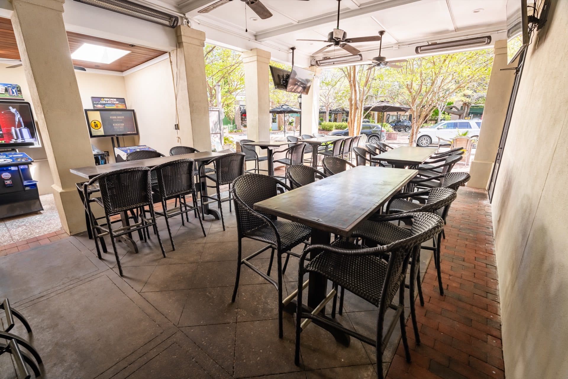 Covered Patio Bar at O'Brion's Pub & Grille — Game Day Outdoor Viewing, Mount Pleasant SC Covered outdoor patio bar at O'Brion's Pub & Grille with high-top seating and multiple TVs showing sports