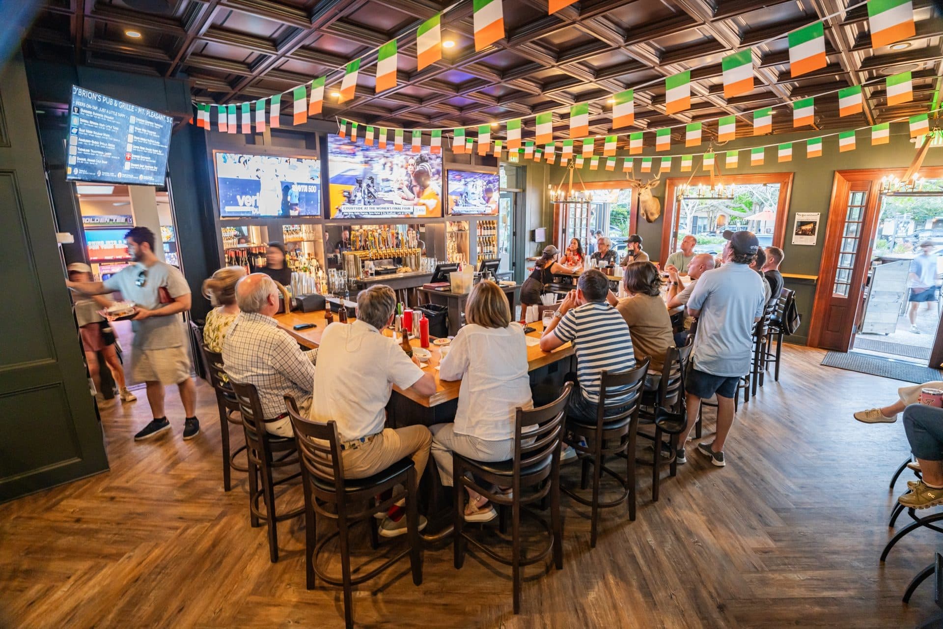 Game Day Crowd at O'Brion's Pub & Grille — Best Sports Bar in Mount Pleasant SC Lively game day crowd seated at the bar at O'Brion's Pub & Grille in Mount Pleasant SC watching sports on multiple TVs