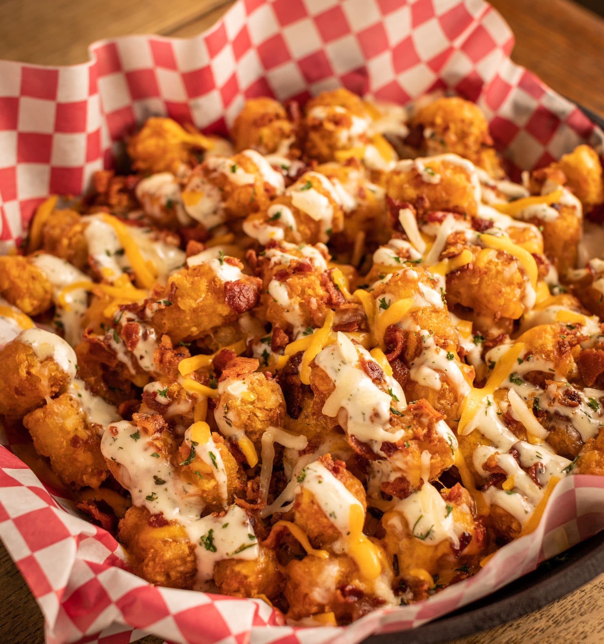 Loaded hangover tots smothered with bacon, shredded cheese, and pub ranch at O'Brion's Pub & Grille