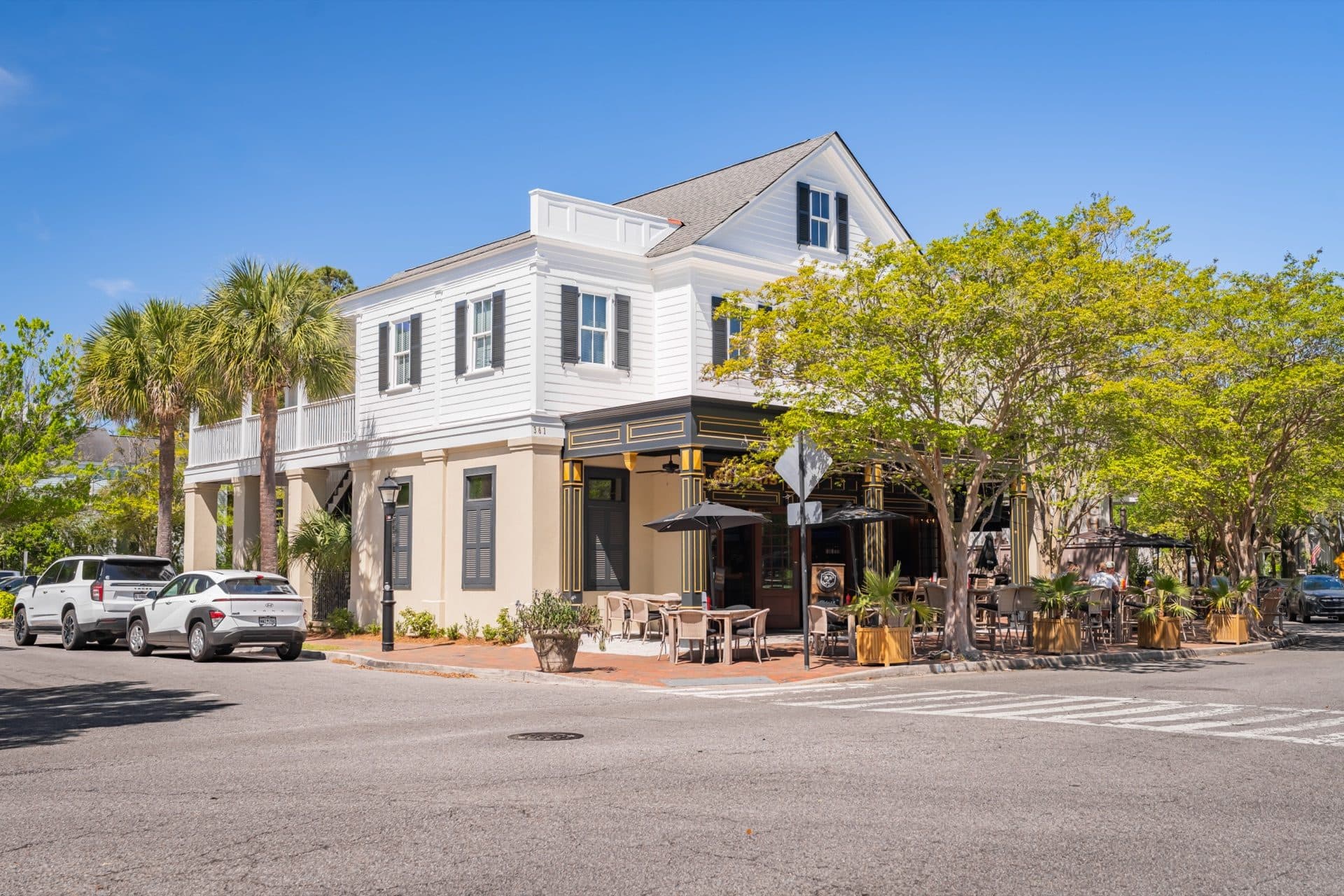 Corner exterior view of O'Brion's Pub & Grille at 361 N Shelmore Blvd in Mount Pleasant SC with palm trees and blue sky