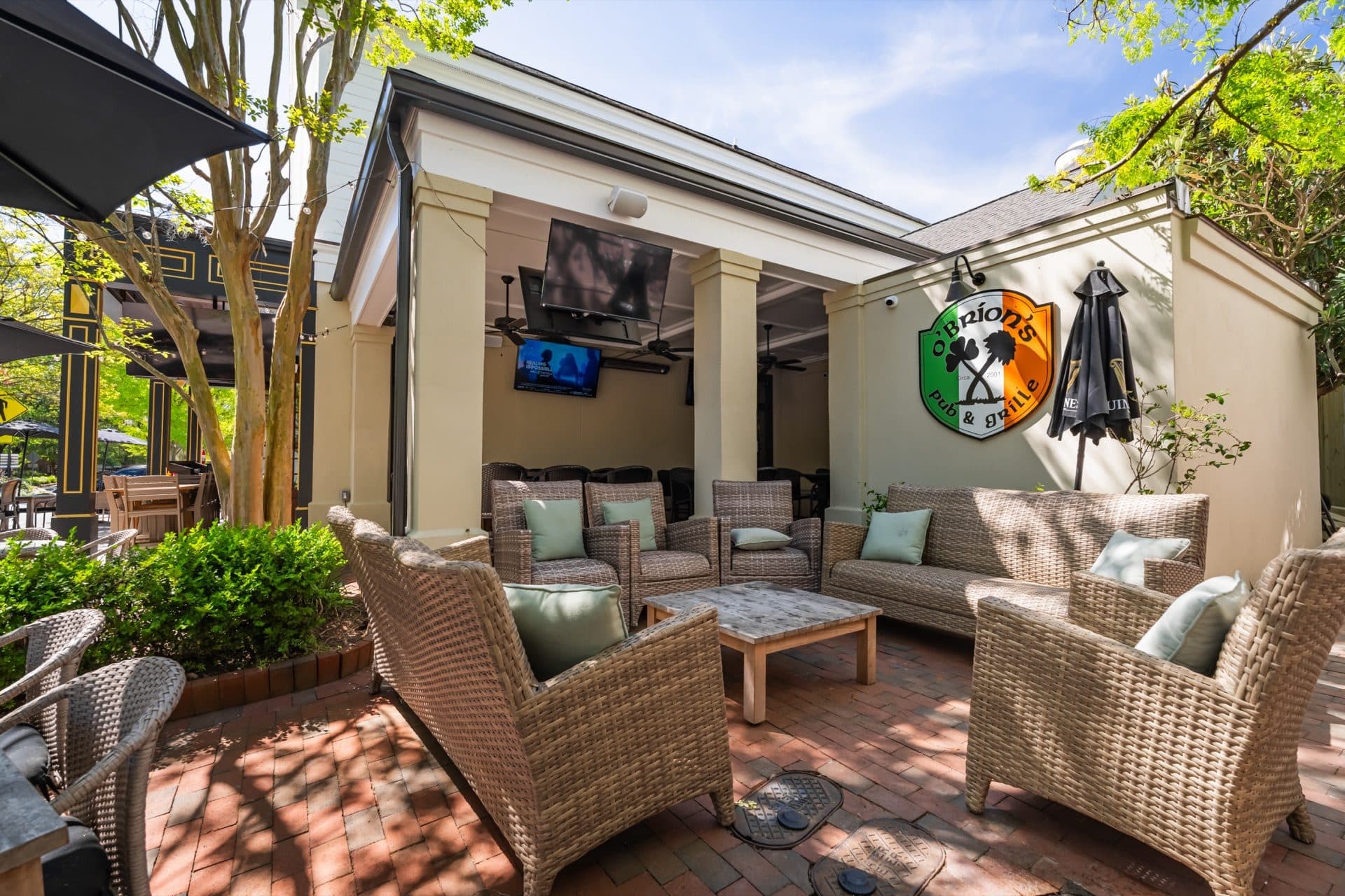 O'Brion's Back Courtyard Lounge — Outdoor Seating at I'On Village Pub Outdoor wicker lounge seating with O'Brion's Pub & Grille sign on the back patio courtyard in Mount Pleasant SC