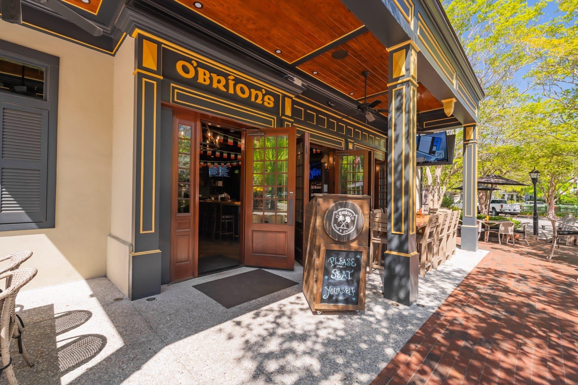Walk In and Seat Yourself — O'Brion's Pub & Grille Front Entrance, Mount Pleasant SC Front entrance of O'Brion's Pub & Grille on Shelmore Blvd showing the O'Brion's sign, open doors, and Please Seat Yourself chalkboard