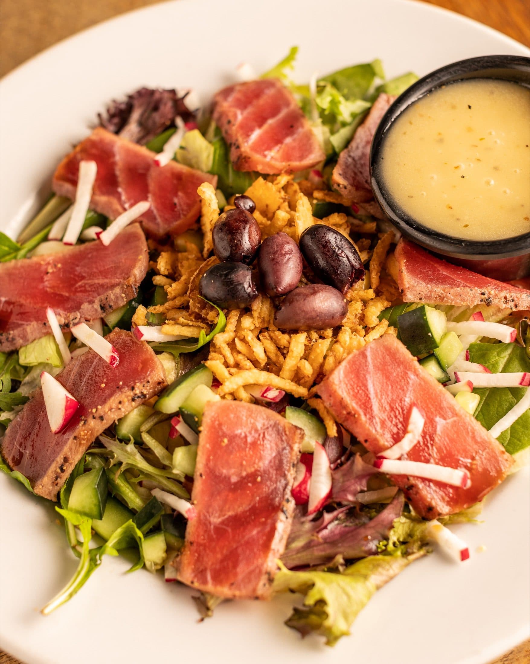 Seared Tuna Salad at O'Brion's Pub & Grille — Light & Fresh, Mount Pleasant SC Seared tuna salad with romaine, spring mix, radish, Kalamata olives, and soy glaze at O'Brion's Pub & Grille